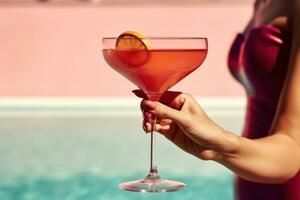 Woman with cocktail near the pool photo