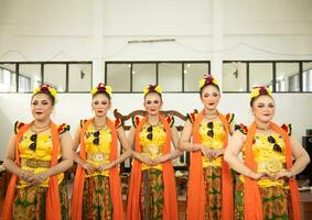 a group of traditional Sundanese dancers standing with their friends before the performance starts photo