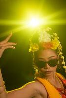 a Javanese dancer dances very skillfully while wearing sunglasses on her eyes and very beautiful facial makeup photo