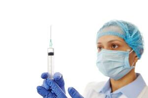 Health worker preparing a vaccine. Doctor holding a syringe with hypodermic needle. Medical concept. Immunization. Vaccination day photo