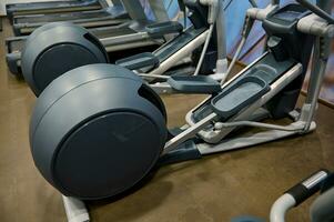 Close-up of sport equipment in fitness centre. Cardio workout concept photo