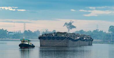 Tug boat with barge vessel in Chao Phraya river at Thailand photo