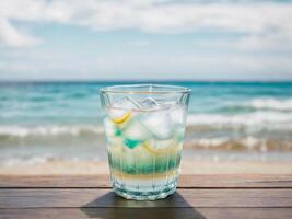 Cold drink in galss cup with beach ocean background, photo