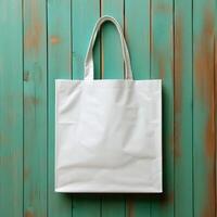 Blank white tote bag mockup isolated on rustic green wooden planks. photo