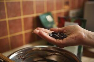 Soft focus on chocolate pills or tablets in confectioner hand. Close Up photo