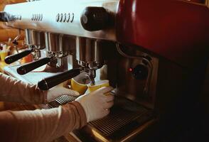 Close-up of espresso pouring from coffee machine. Professional coffee brewing photo
