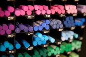 Selective focus on bright colorful pastel pencils and crayons in cool colors, displayed for sale on a shelf in art store photo