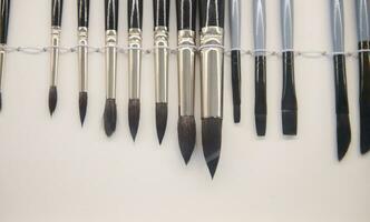 Paintbrushes of various sizes with wooden handle and natural bristle, displayed for sale. Art, creativity and painting photo