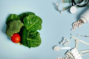 Scattered pharmaceutical pills, blisters of tablets, insulin syringe, stethoscope, measuring tape, refined sugar on blue background, healthy vegan food. Diabetes Awareness Day concept, 14 November photo