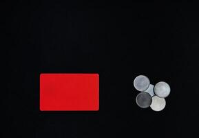 St. Valentines Day concept. A horizontal red rectangle and money coins on a black background .Border, copy space, top view, celebration, holiday photo