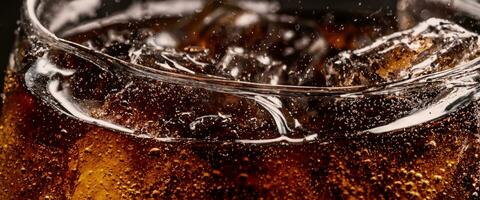 Cola soda and ice splashing fizzing or floating up to top of surface photo