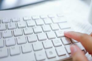 Hands of business woman Pressing enter button on computer keyboard photo