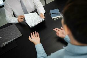 Examiner reading a resume during job interview at office Business and human resources concept. photo