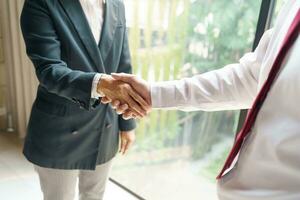 Businessman shaking hands successful making a deal. mans handshake. Business partnership meeting concept photo