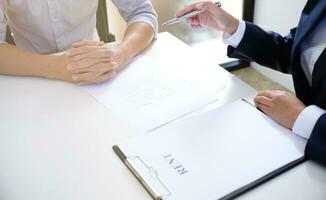 Sales manager giving advice application form document, considering mortgage loan offer for car and house insurance. photo