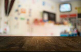 Empty dark wooden table in front of abstract blurred bokeh background of restaurant . can be used for display or montage your products.Mock up for space. photo