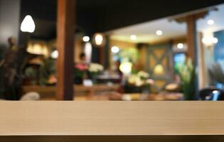 Empty wooden table in front of abstract blurred background of coffee shop . can be used for display or montage your products.Mock up for display of product photo