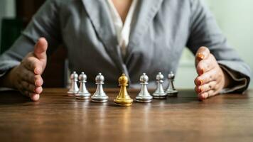 Chess leader and team. Human resources concept career management with clasped hands planning strategy with chess figures. leadership or success teamwork. Inspiration idea of goal photo