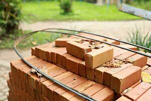 Pallet a red brick building material stack of new red bricks for construction. photo