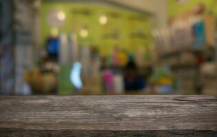 Empty wooden table in front of abstract blurred background of coffee shop . can be used for display or montage your products.Mock up for display of product photo