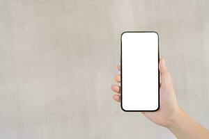 Women's hands holding cell telephone blank copy space screen. smartphone with blank white screen isolated. smart phone with technology concept. photo