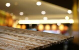 Empty wooden table in front of abstract blurred background of coffee shop . can be used for display or montage your products.Mock up for display of product photo