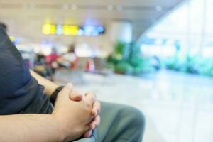 Man waiting for flight in airport departure area at airport waiting the flight photo