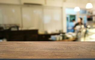 Empty wooden table in front of abstract blurred background of coffee shop . can be used for display or montage your products.Mock up for display of product photo