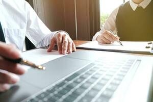 Businessman analyzing investment charts and pressing calculator buttons over documents. Accounting Concept. photo