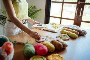 Punch needle. Asian Woman making handmade Hobby knitting in studio workshop. designer workplace Handmade craft project DIY embroidery concept. photo