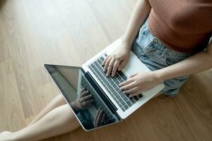 Woman Working by using laptop blank screen computer . Hands typing on a keyboard.technology e-commerce concept. photo