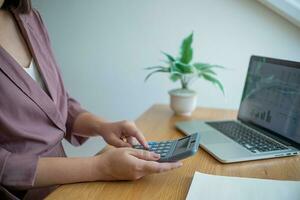 Business women checking  bills. taxes bank account balance and calculating  annual financial statements of company. Accounting  Audit Concept photo