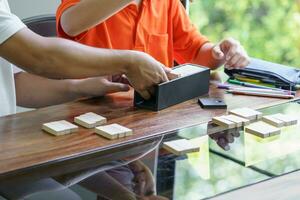 Asian father and son playing wood blocks game Carefree kid playing wood blocks game building constructor from blocks with father at home photo