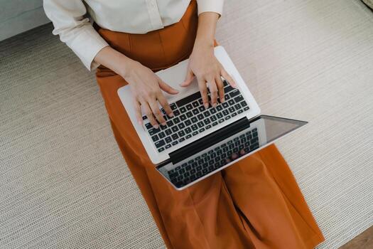 Working by using a laptop computer on wooden table. Hands typing on a keyboard.technology e-commerce concept photo