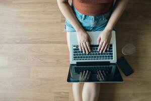 Woman Working by using laptop blank screen computer . Hands typing on a keyboard.technology e-commerce concept. photo