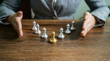Chess leader and team. Human resources concept career management with clasped hands planning strategy with chess figures. leadership or success teamwork. Inspiration idea of goal photo