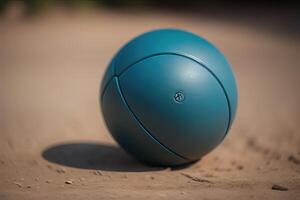Blue fitness ball on the sand in the park. Selective focus. photo