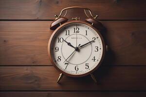 Retro alarm clock on wooden background. Vintage alarm clock on wooden background. photo