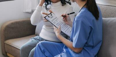 Homecare nursing service and elderly people cardiology healthcare. Close up of young hispanic female doctor nurse check mature caucasian man patient heartbeat using stethoscope during visit photo