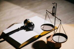 Justice and law concept.Male judge in a courtroom with the gavel, working with, computer and docking keyboard, eyeglasses, on table in morning light photo