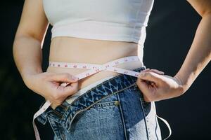 fat woman, fat belly, chubby, obese woman hand holding excessive belly fat with measure tape, woman diet lifestyle concept photo