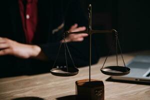 Justice and law concept.Male judge in a courtroom with the gavel, working with, computer and docking keyboard, eyeglasses, on table in morning light photo