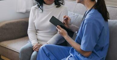 Homecare nursing service and elderly people cardiology healthcare. Close up of young hispanic female doctor nurse check mature caucasian man patient heartbeat using stethoscope during visit photo