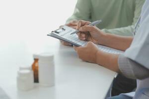 A health visitor with tablet explaining a senior woman how to take pills. photo