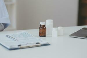 A health visitor with tablet explaining a senior woman how to take pills. photo