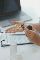 A health visitor with tablet explaining a senior woman how to take pills. photo