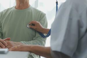 A health visitor with tablet explaining a senior woman how to take pills. photo