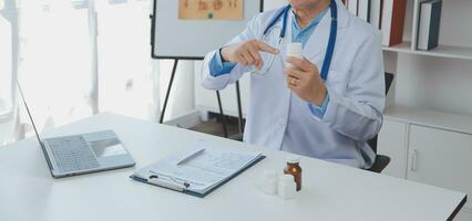 A health visitor with tablet explaining a senior woman how to take pills. photo