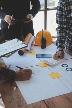 Construction and structure concept of Engineer or architect meeting for project working with partner and engineering tools on model building and blueprint in working site, contract for both companies. photo