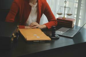 Business and lawyers discussing contract papers with brass scale on desk in office. Law, legal services, advice, justice and law concept picture with film grain effect photo